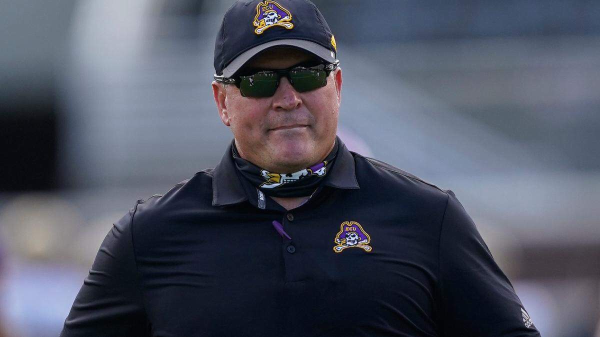 East Carolina head coach Mike Houston runs the sidelines during the half of an NCAA college football game against Central Florida in Greenville, N.C., Saturday, Sept. 26, 2020. (AP Photo/Gerry Broome)