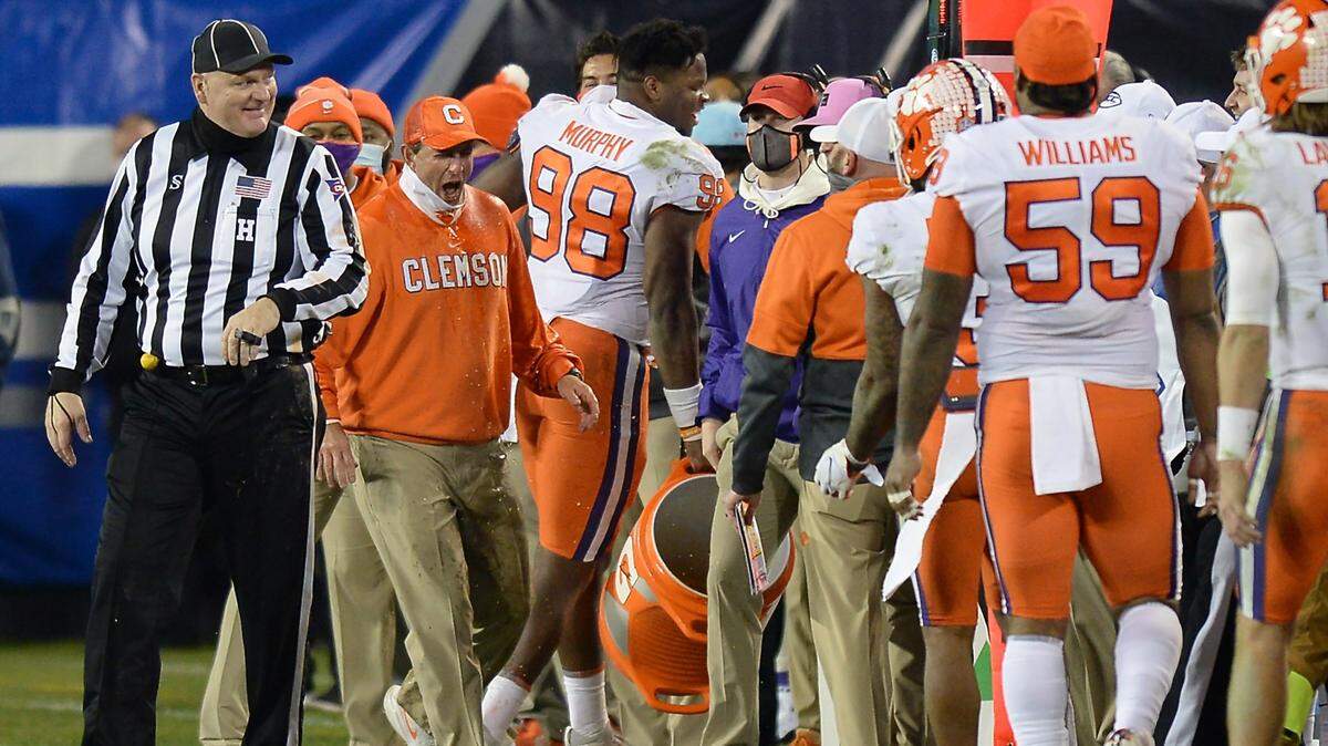 Clemson Tigers head coach Dabo Swinney, left, reacts after receiving a Gatorade bath in the closing moments of the ACC Championship game in December at Bank of America Stadium in Charlotte. The Tigers return to uptown Charlotte next Saturday to play Georgia.