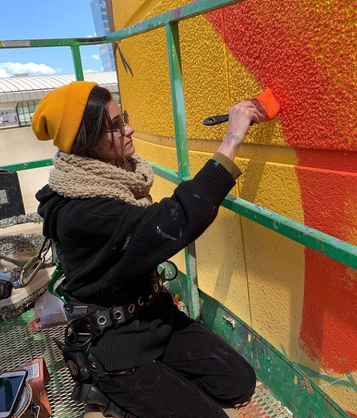 Painting a mural is hard, physical work. Sam Guzzie would push herself to work up to 12-hour days on the uptown mural of photographer Dionna Bright.
