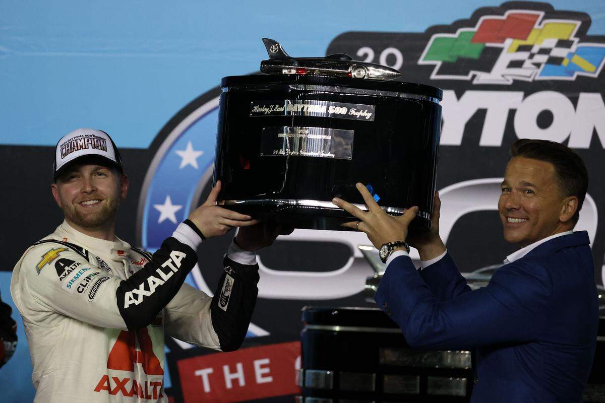 Feb 19, 2024; Daytona Beach, Florida, USA; NASCAR Cup Series driver William Byron (24) poses with the Daytona 500 trophy at Daytona International Speedway. Mandatory Credit: Peter Casey-USA TODAY Sports