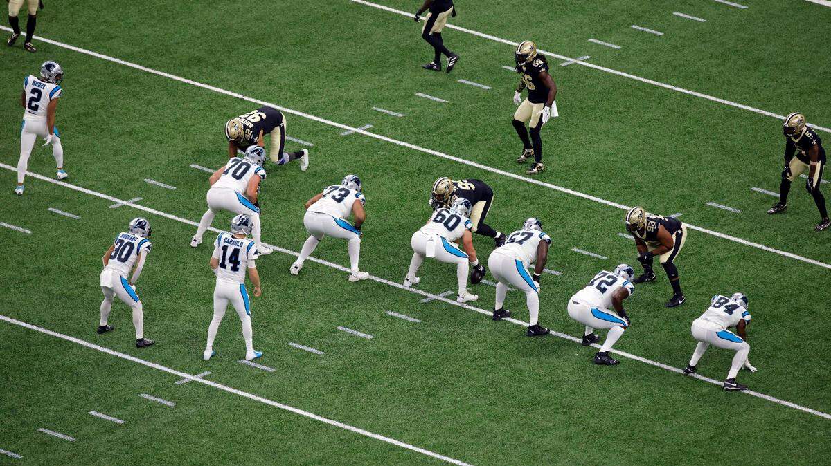 Carolina Panthers quarterback Sam Darnold (14) waits for Pat Elflein (60) to snap the ball during Sunday’s game against the New Orleans Saints.