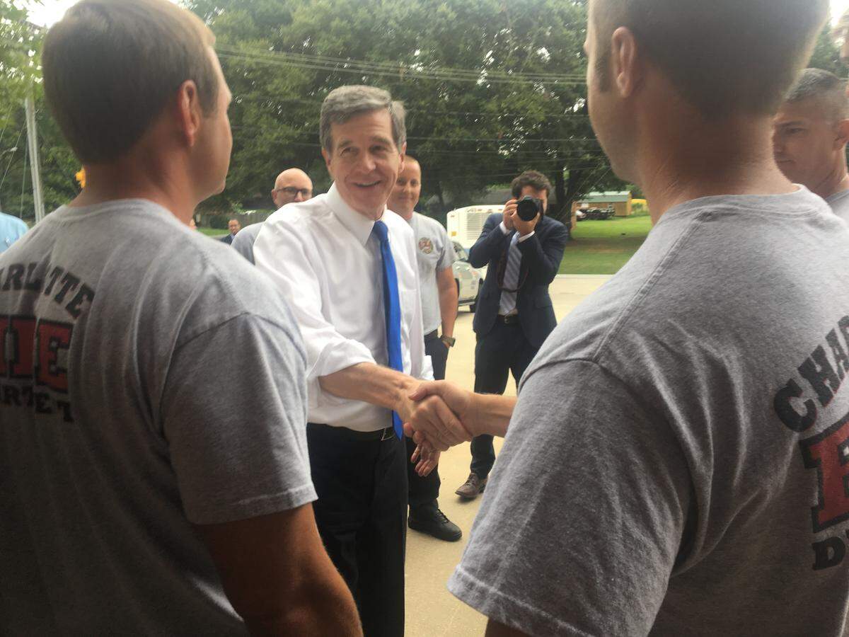Governor Roy Cooper shook hands with residents and firefighters in the area devastated by rising Catawba River floodwaters last month.