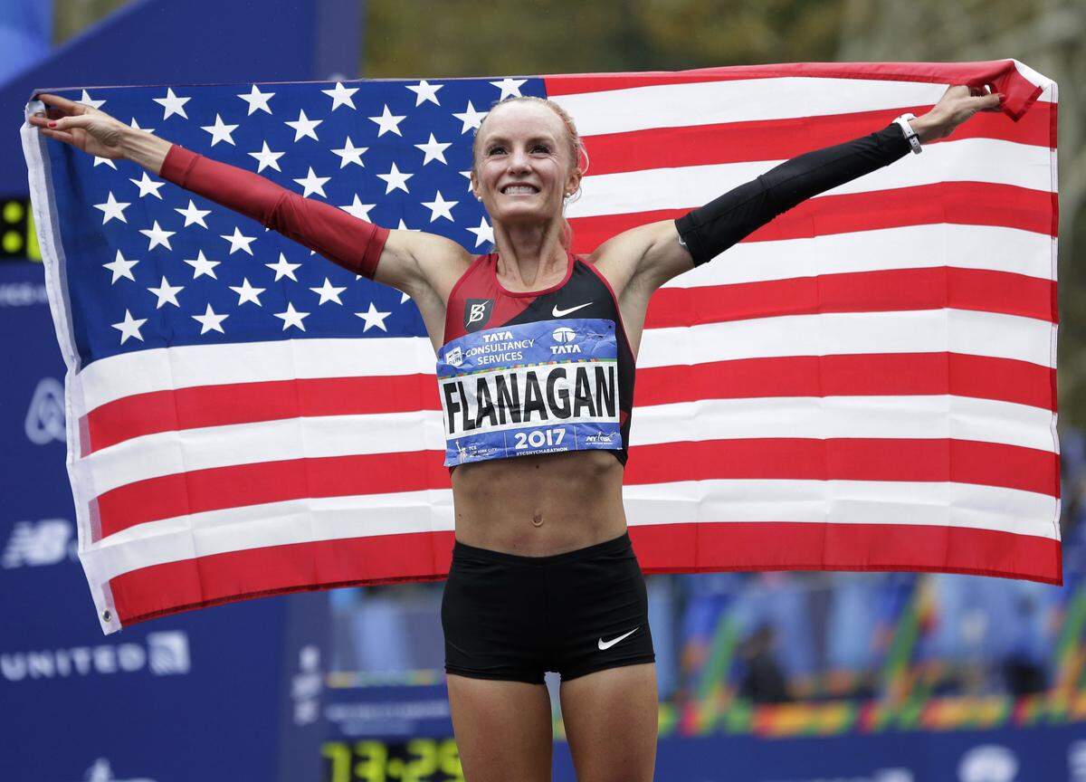 Shalane Flanagan of the United States poses for pictures after crossing the finish line first in the women’s division of the New York City Marathon in New York, Sunday, Nov. 5, 2017. (AP Photo/Seth Wenig)