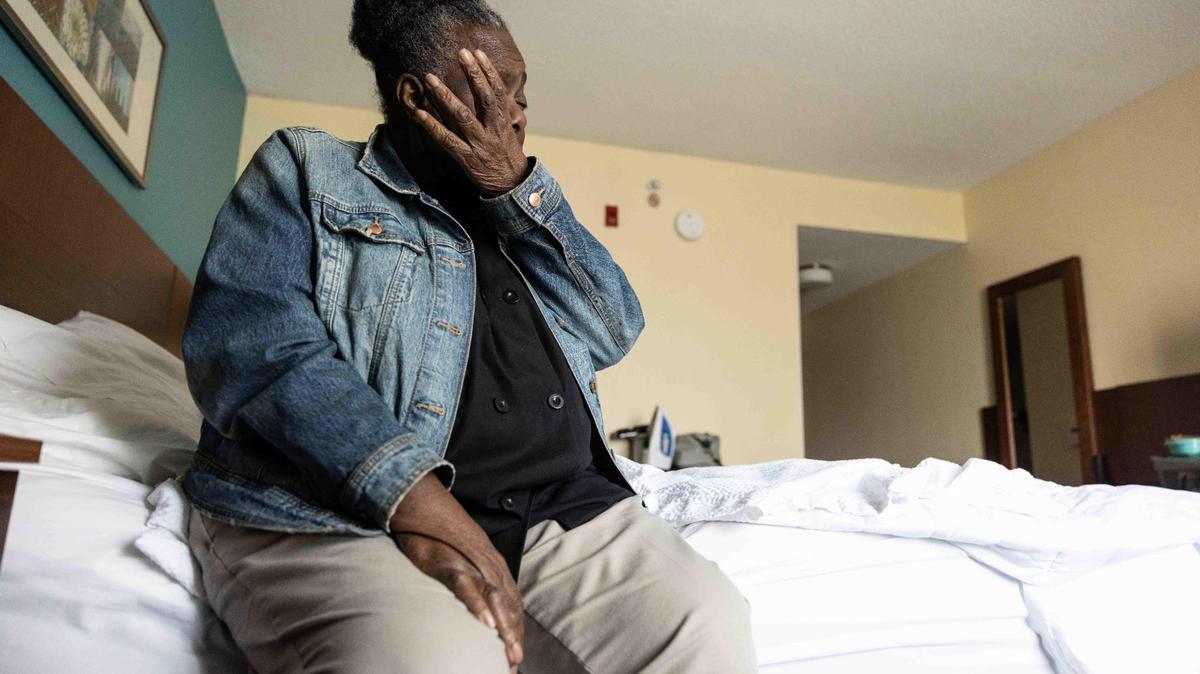 Betty Johnson wipes away tears as she talks about her living situation after she was displaced from Magnolia Senior Apartments because of a water leak on Christmas Day in Charlotte, N.C., on Friday, March 10, 2023.