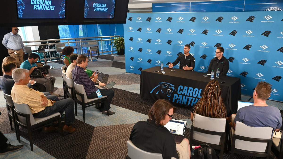 Carolina Panthers head coach Dave Canales, left, answers a question as general manager Dan Morgan, right, listens during a pre-draft press conference at Bank of America Stadium on Thursday, April 18, 2024.