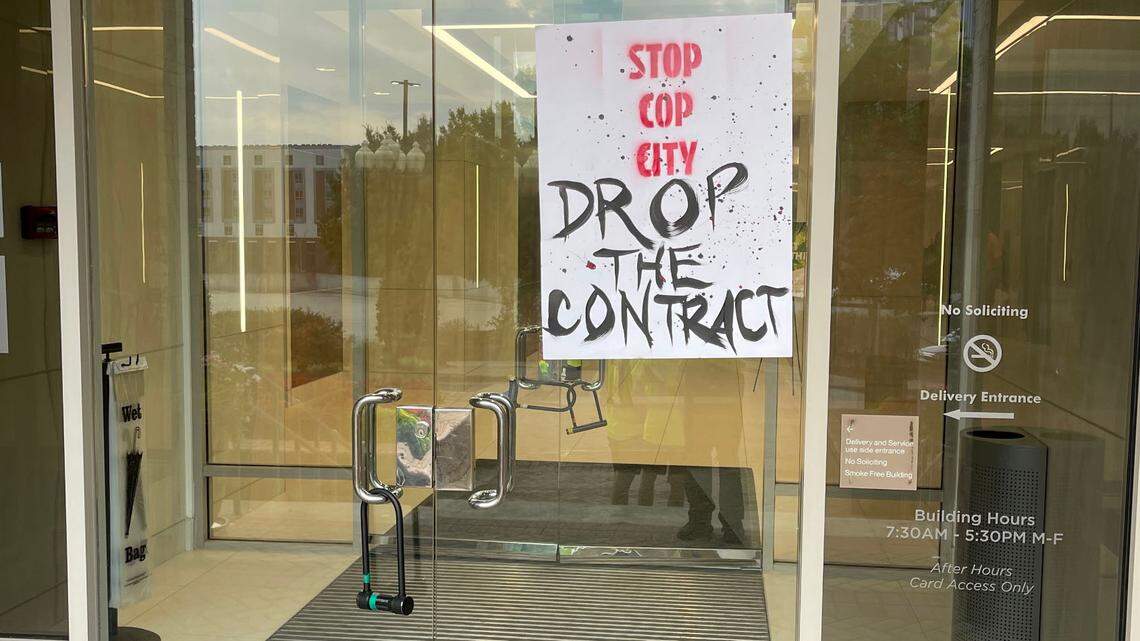 On one of the entrance doors, protesters left a poster that said “Stop Cop City. Drop the Contract.” The sign demands that Charlotte-based construction company Brasfield & Gorrie end its contract with Atlanta, which commissioned the company to build a police training facility.