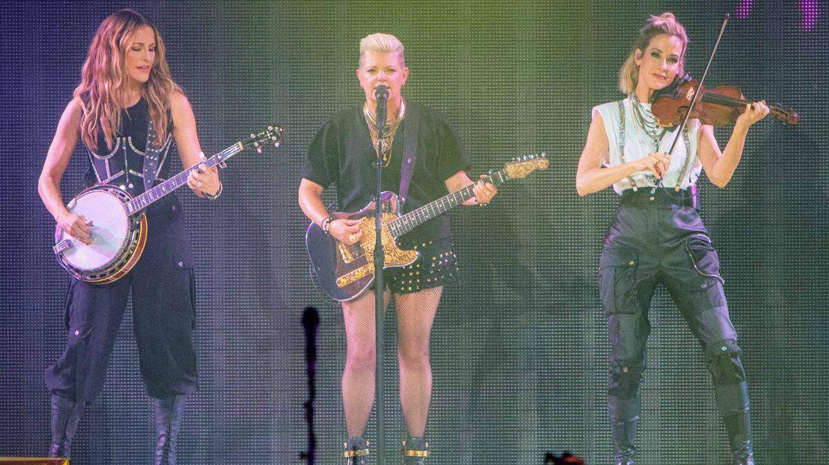 Members of The Chicks, Emily Strayer, Natalie Maines and Martie McGuire, perform at PNC Music Pavilion in Charlotte.