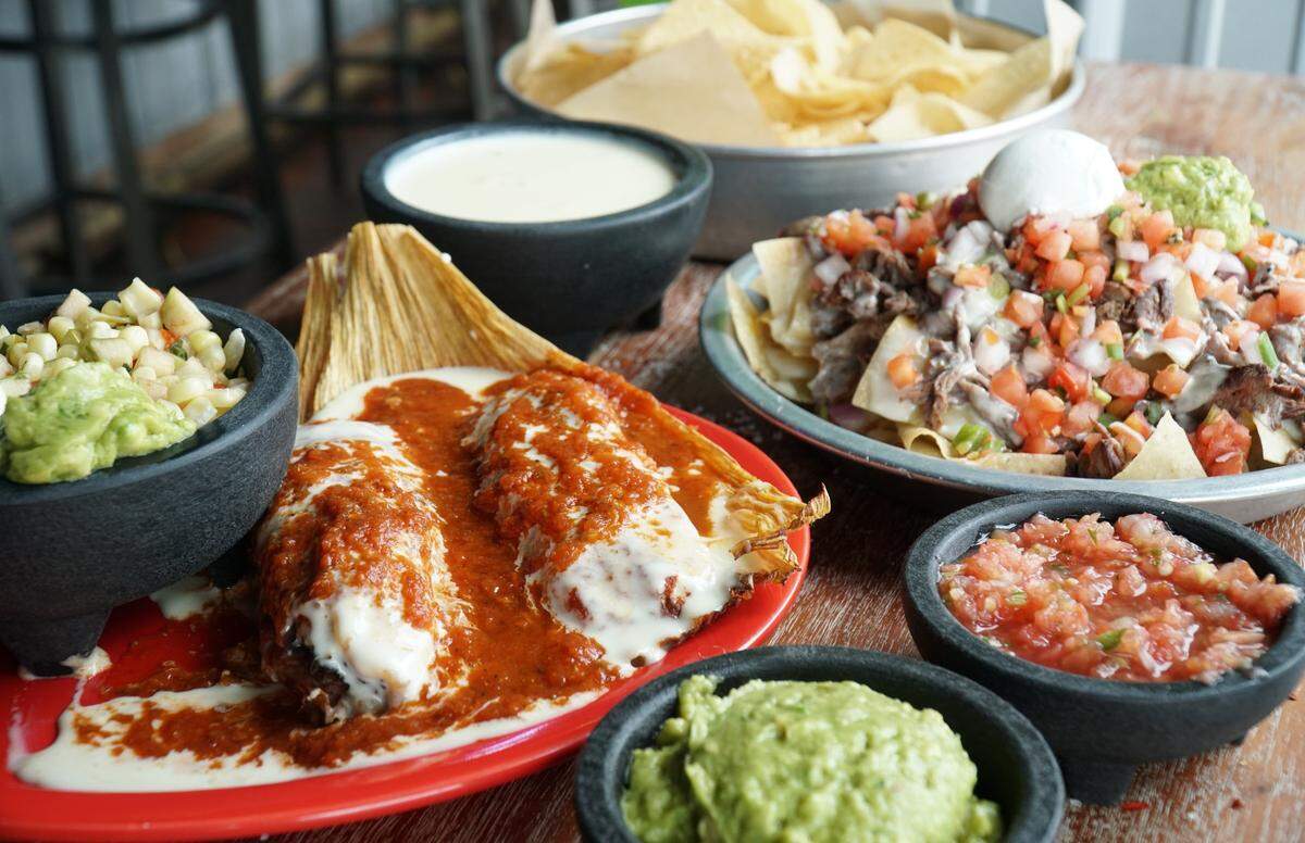 Tipsy Taco’s tamales ($10.50) are served with cheddar, queso and enchilada sauce on top.