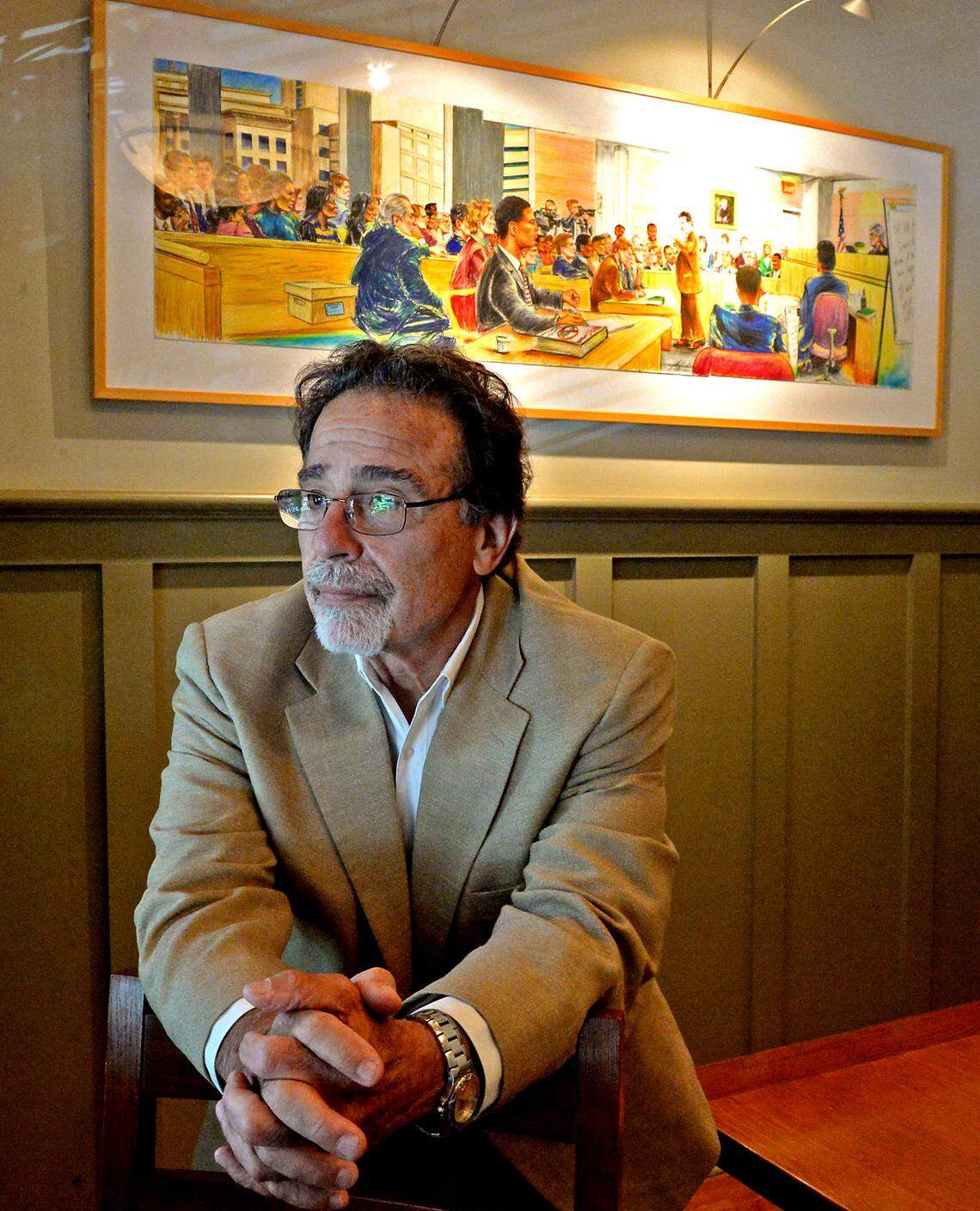 Inside Rudolf’s conference room, on the back wall, hangs a painting of a courtroom scene from the Carruth trial. It resembles a courtroom sketch, only in color and more detailed. Various celebrities sit in the background, watching Rudolf work.