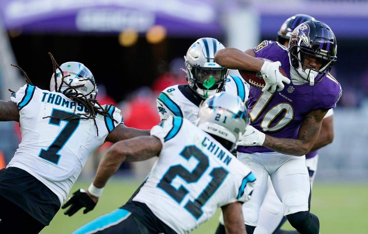 Baltimore Ravens wide receiver Demarcus Robinson (10) tries to get by Carolina Panthers safety Jeremy Chinn (21) and teammate Shaq Thompson (7) in the second half of an NFL football game Sunday, Nov. 20, 2022, in Baltimore. (AP Photo/Patrick Semansky)