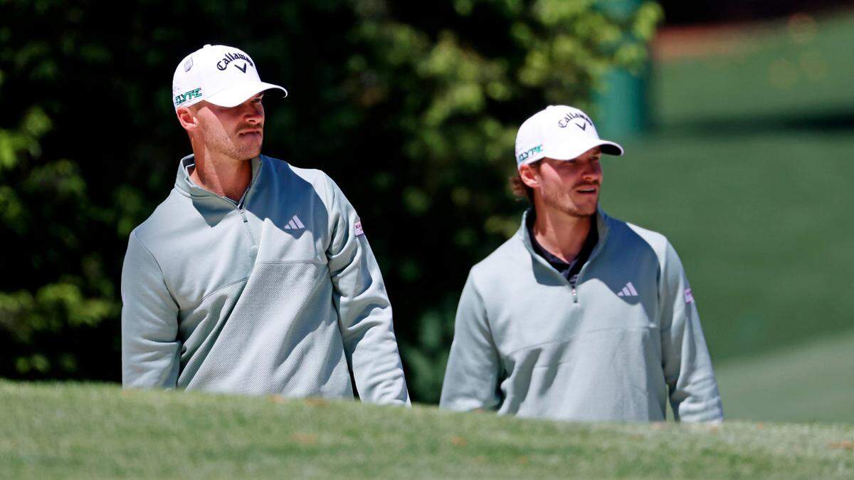 Nicolai Hojgaard and Rasmus Hojgaard walk on the 10th green during a practice round Tuesday for the Masters Tournament at Augusta National Golf Club. 