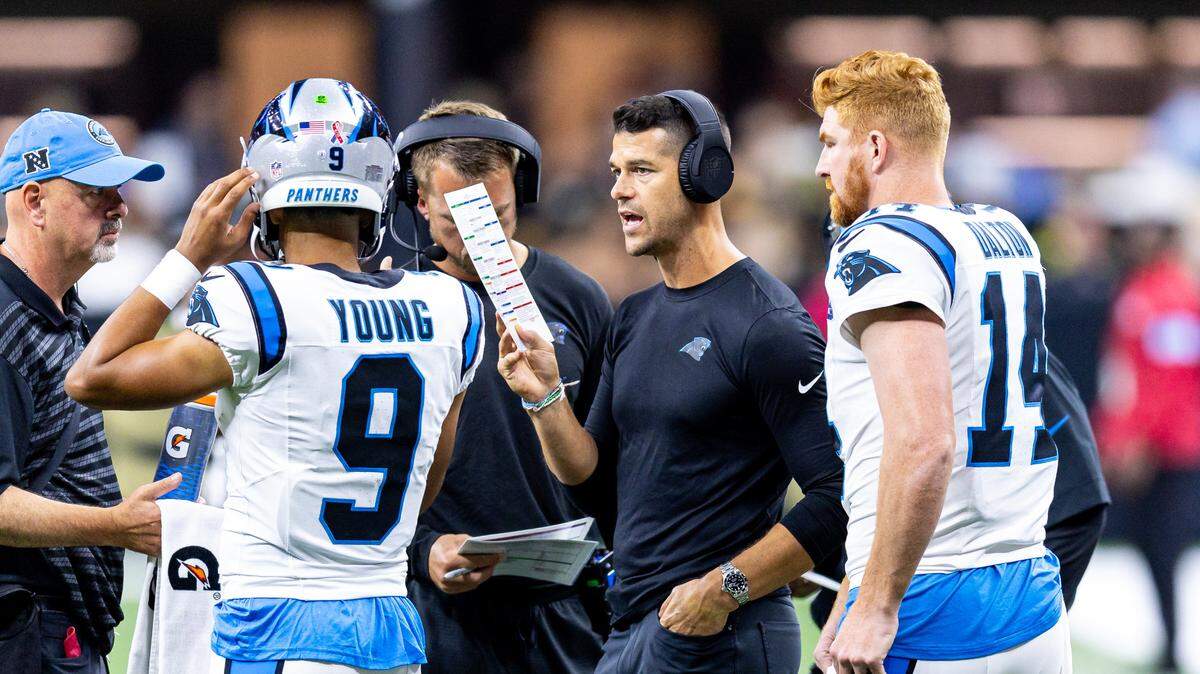 Carolina Panthers head coach Dave Canales talks to quarterback Bryce Young (9) and quarterback Andy Dalton (14) on a time out against the New Orleans Saints during the first half at Caesars Superdome.