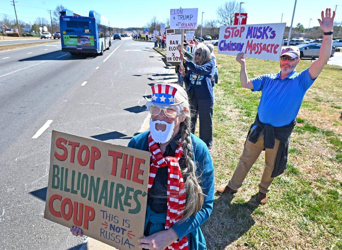 Margie Storch dressed as Uncle Sam stands along E. Independence Blvd. rallying against Elon Musk and DOGE in front of the Tesla car dealership in Matthews, NC on Friday, February 28, 2025.