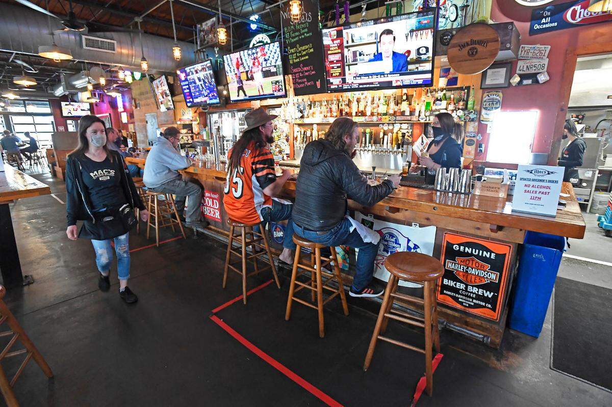 Customers eat at the bar at Mac’s Speed Shop on South Boulevard on March 15. Mac’s Hospitality Group has seen a 520% increase in takeout and delivery during the coronavirus pandemic.