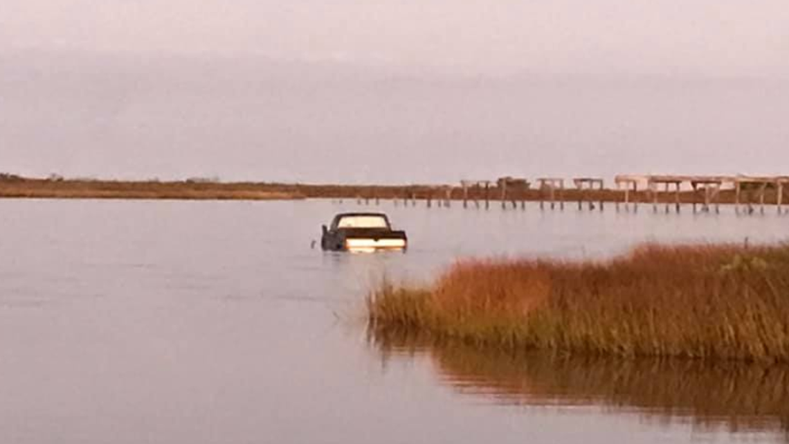 Theories abound on why a pickup truck is sitting in the Pamlico Sound at the New Inlet. The photo was taken Sept. 25 by a landscaping company.