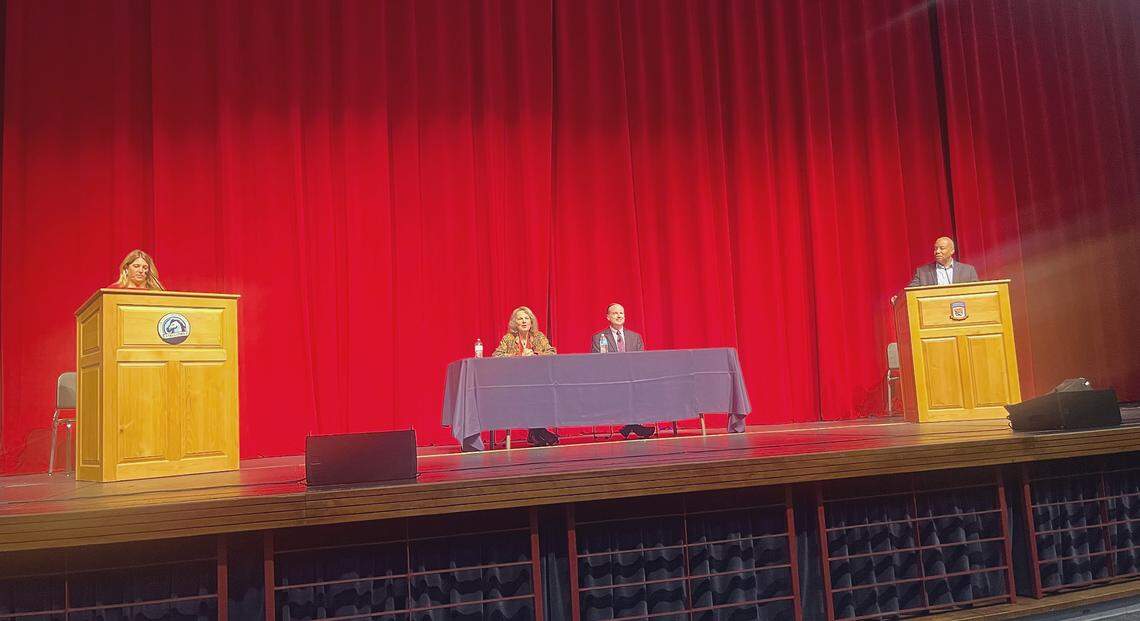 Republican Michele Morrow, pictured far left, and Democrat Mo Green, pictured far right, participated in a state superintendent debate Monday night in Pinehurst. At the table in the middle are moderators John Hood, president of the John William Pope Foundation, and former state Sen. Leslie Winner.