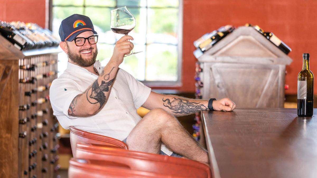 Counter- chef and owner Sam Hart raises a glass. 