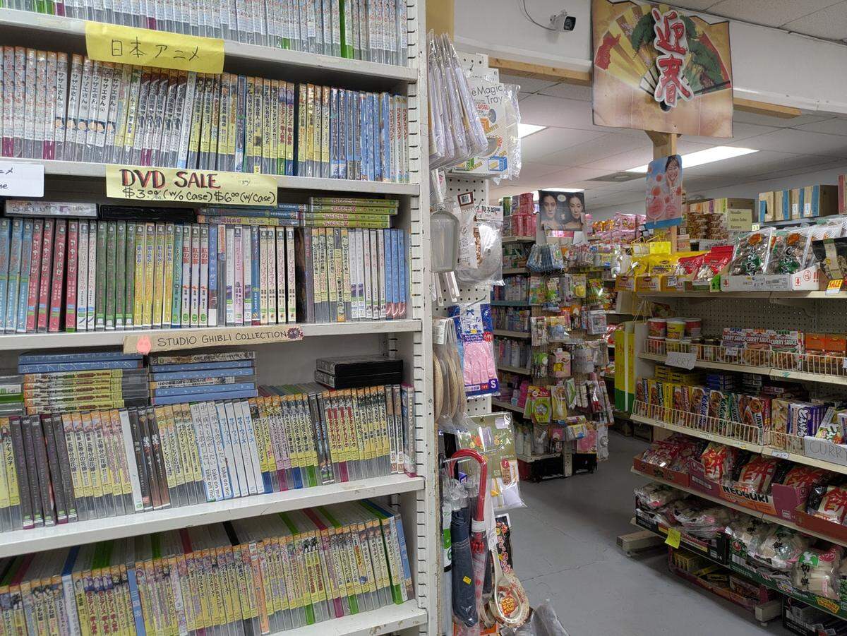 Japanese language DVDs and anime are for sale along with grocery items at Hatoya Market.