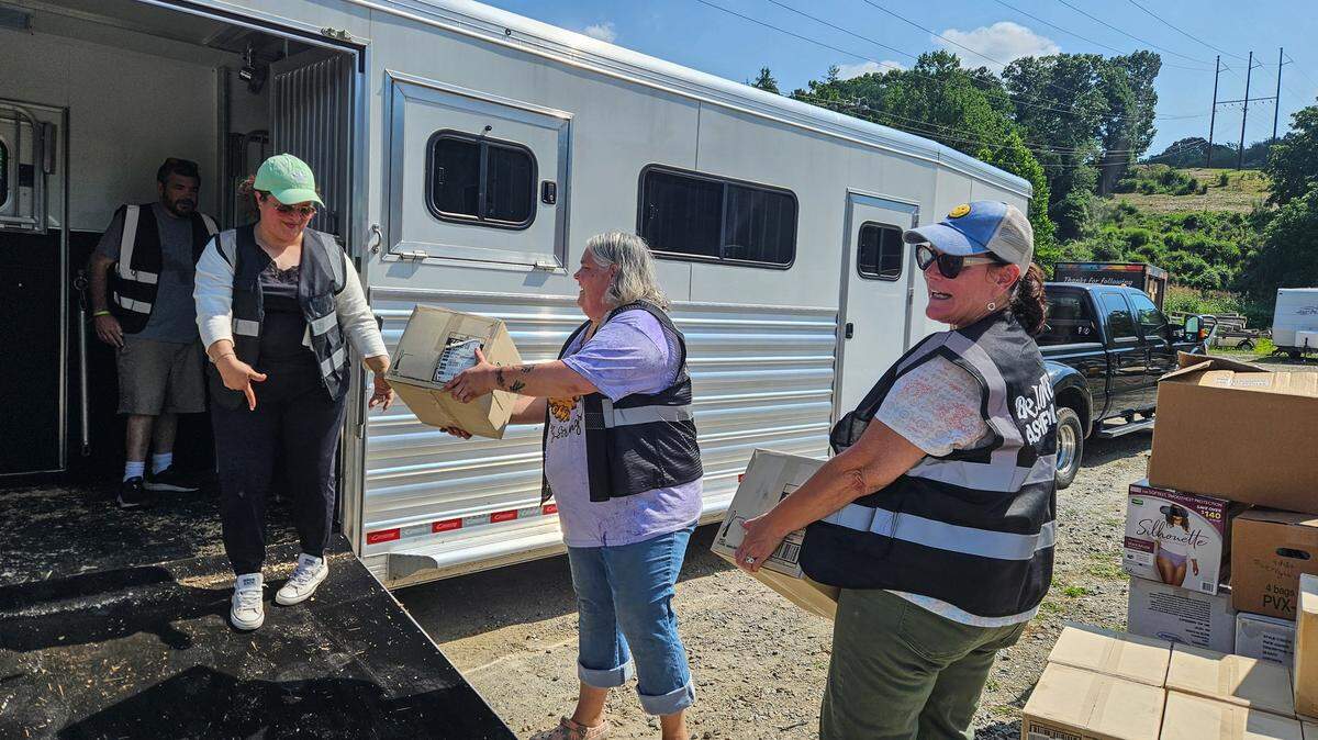 Volunteers with BeLoved Asheville pack trailers with supplies at the nonprofit’s Asheville headquarters before deploying to Texas for flood relief.
