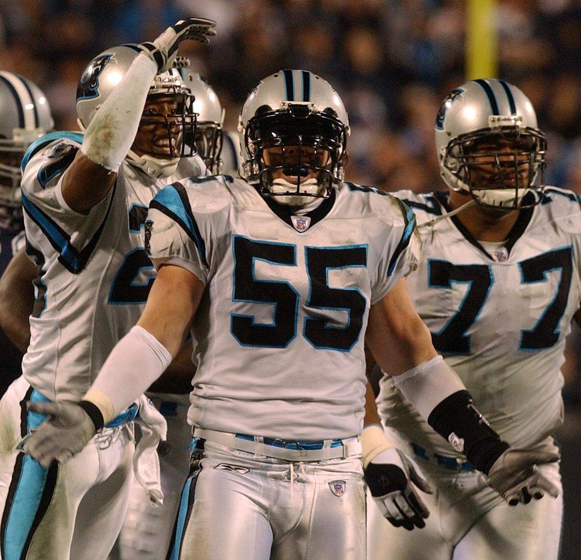 Carolina Panthers linebacker Dan Morgan (55) celebrates a play alongside defensive tackle Kris Jenkins (77). Along with wide receiver Steve Smith, Morgan and Jenkins were both Pro Bowlers who came to the Panthers in the 2001 NFL draft.