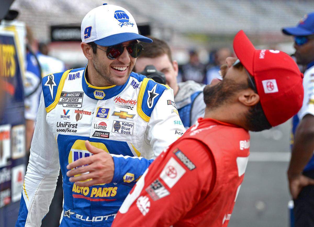 NASCAR Cup driver Chase Elliott, left, jokes with driver Bubba Wallace, right, prior to their qualifying runs for the Coca-Cola 600 at Charlotte Motor Speedway on Saturday, May 29, 2021. Elliott has been the sports most popular driver for three straight years and will be competing to win the Coca-Cola 600 on Sunday, May 30, 2021.