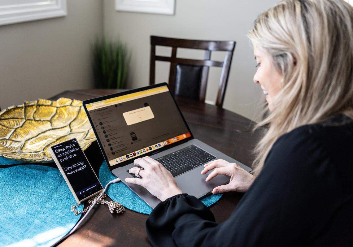 McKinnon Galloway reads a message from a fan out loud as her phone that she uses to communicate dictates what she says at home in Cornelius, N.C., on Thursday, March 20, 2026.
