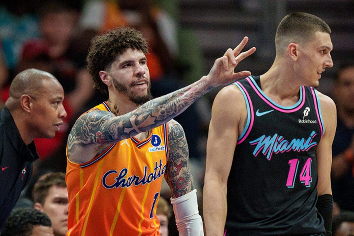 LaMelo Ball of the Charlotte Hornets reacts after making a shot while guarded by Tyler Herro of the Miami Heat during their game at Spectrum Center on March 06, 2026.