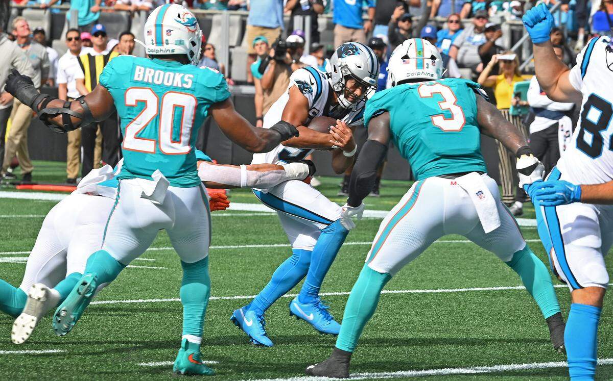 Carolina Panthers quarterback Bryce Young, center, cradles the ball as he runs to the one-yard line during fourth quarter action against the Miami Dolphins on Sunday, October 5, 2025 at Bank of America Stadium in Charlotte, NC. The Panthers defeated the Dolphins 27-24.