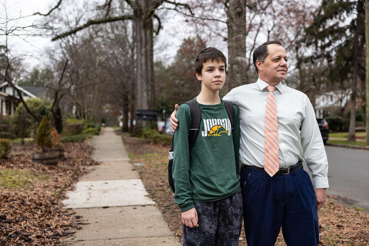 Frank Hruby, right, and his son, Alexander, pose for a portrait on their street in Charlotte, N.C., on Wednesday, February 1, 2023.
