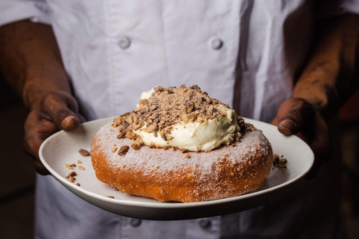 Stoke’s one-pound doughnut is a brioche doughnut topped with diplomat cream, heath bar crumbles, and powdered sugar.