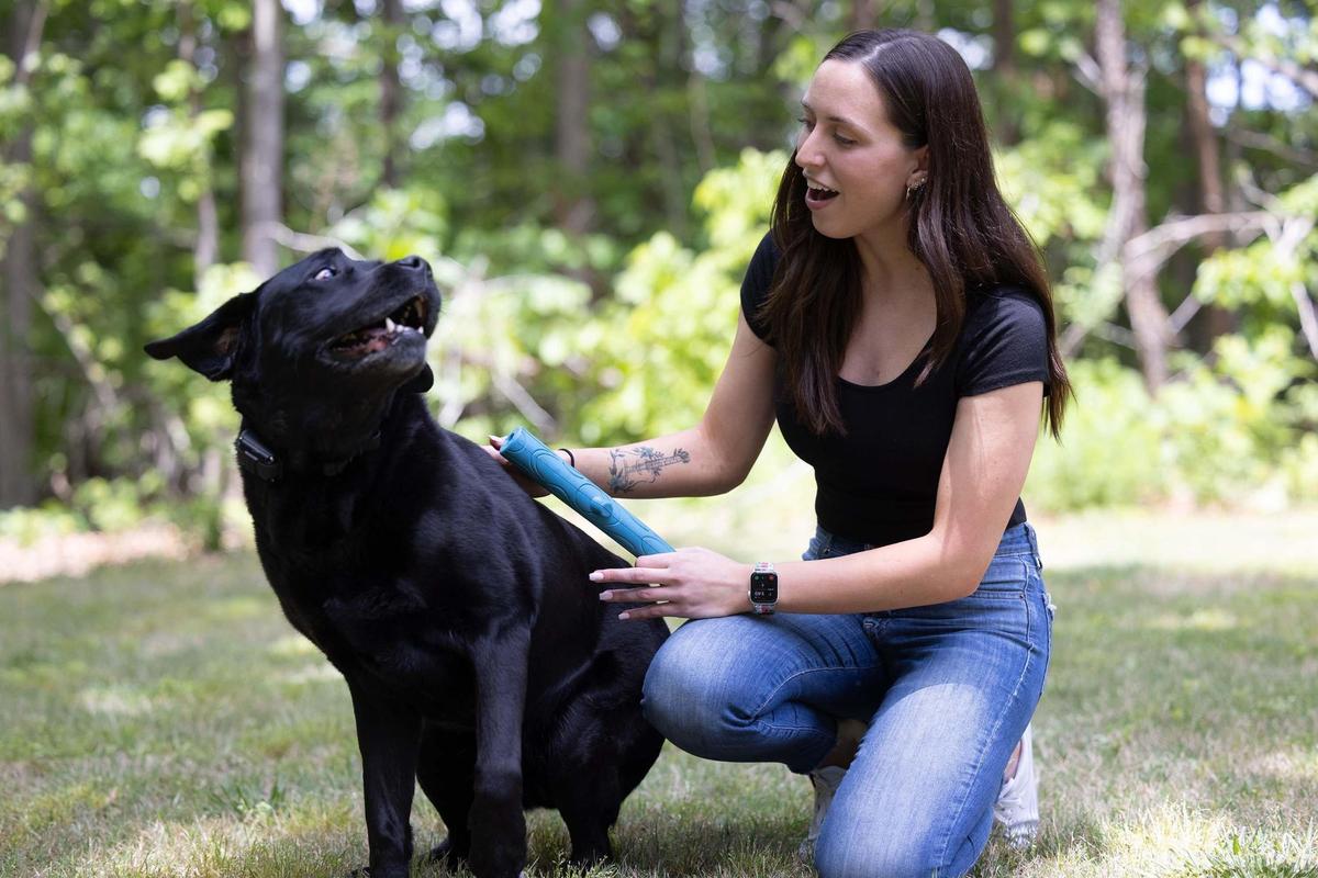 Kristiana Rigney plays with her family dog, Rocky, in Mooresville, on Thursday, May 5, 2022. Rigney recently returned home from surgery in Kansas to repair her rapidly beating heart.