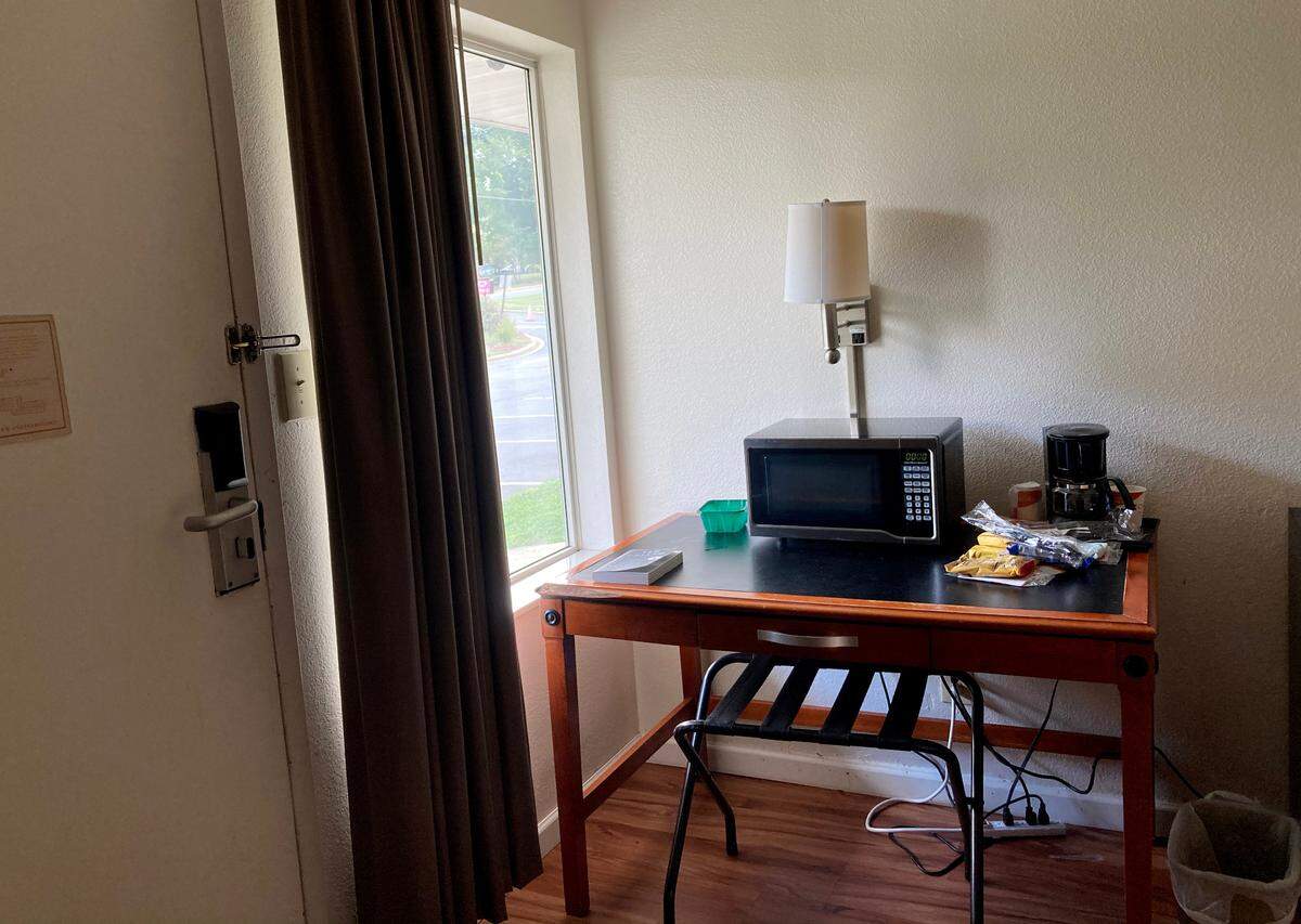 Inside view of Aaron Hall’s first room at the COVID-19 quarantine hotel. The room Hall was given lacked a chair for the desk, so Hall used the luggage stand as chair before switching rooms because of mold.