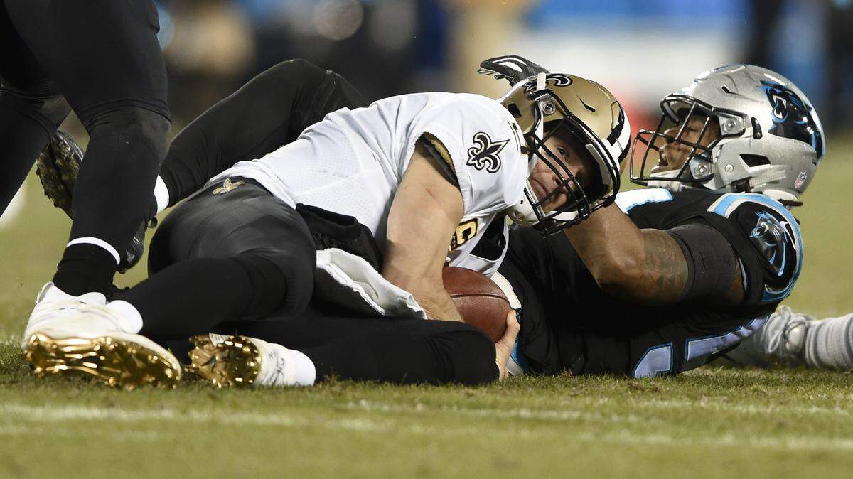 New Orleans Saints’ Drew Brees, front, is sacked by Carolina Panthers’ Shaq Green-Thompson, back, in the second half of an NFL football game in Charlotte, N.C., Monday, Dec. 17, 2018. (AP Photo/Mike McCarn)