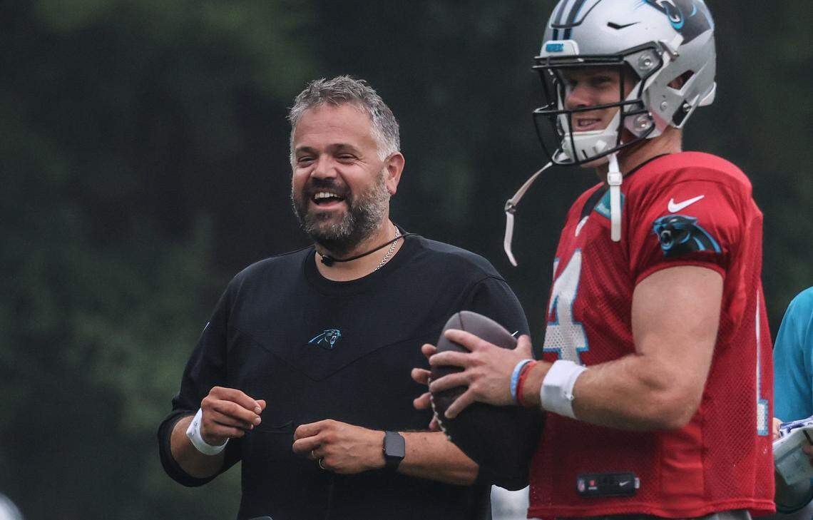 Carolina Panthers Coach Matt Rhule, left, shares a laugh with QB Sam Darnold at the Carolina Panthers training camp at Wofford College in Spartanburg, S.C., on Tuesday, August 3, 2021.