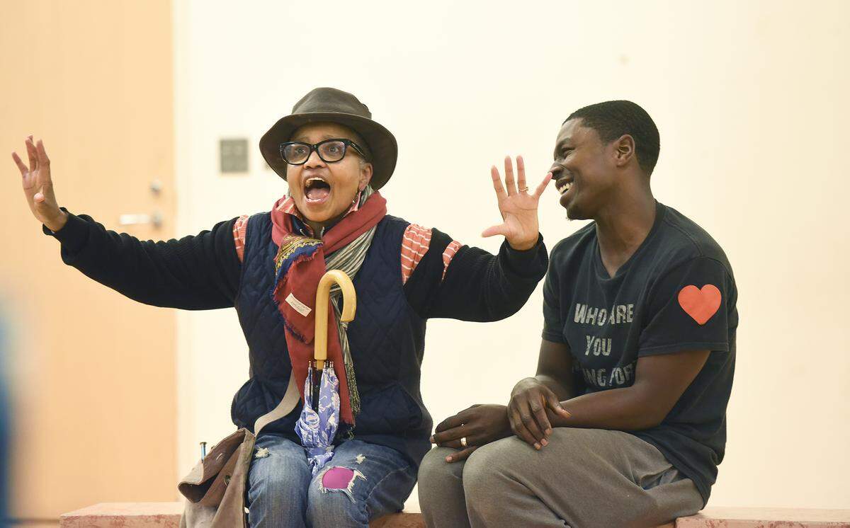 Nana (Corlis Hayes) and CJ (Rahsheem Shabaz) wait for their ride on the dragon bus during a rehearsal of “Last Stop on Market Street.”