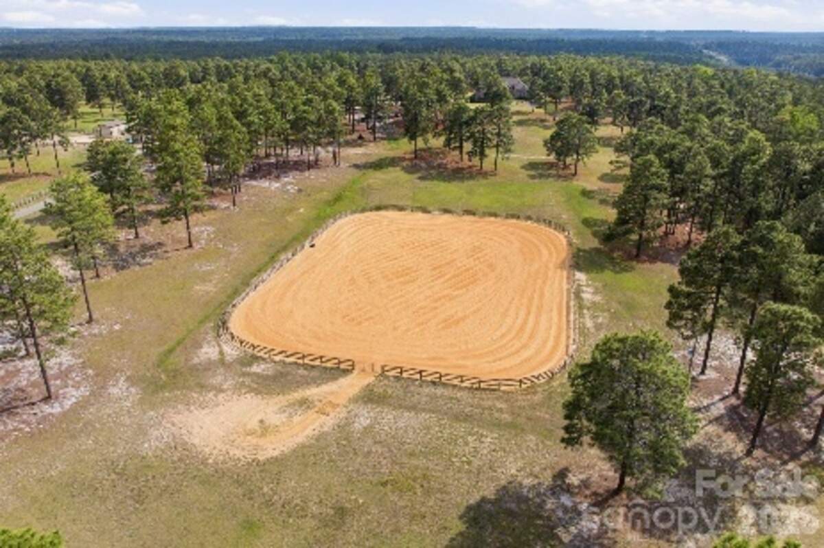 The mansion grounds include professionally designed horse riding areas.