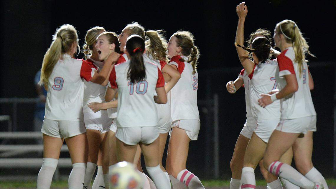 Charlotte Catholic’s Marguerite McPhillps, second from left, rejoices with her teammates after scoring a late second-half goal to break a 2-2 tie and win the game for the Cougars. Charlotte Catholic traveled to Marvin Ridge for an evening match between two teams ranked in the top 10 nationally on Friday, April 17, 2026.