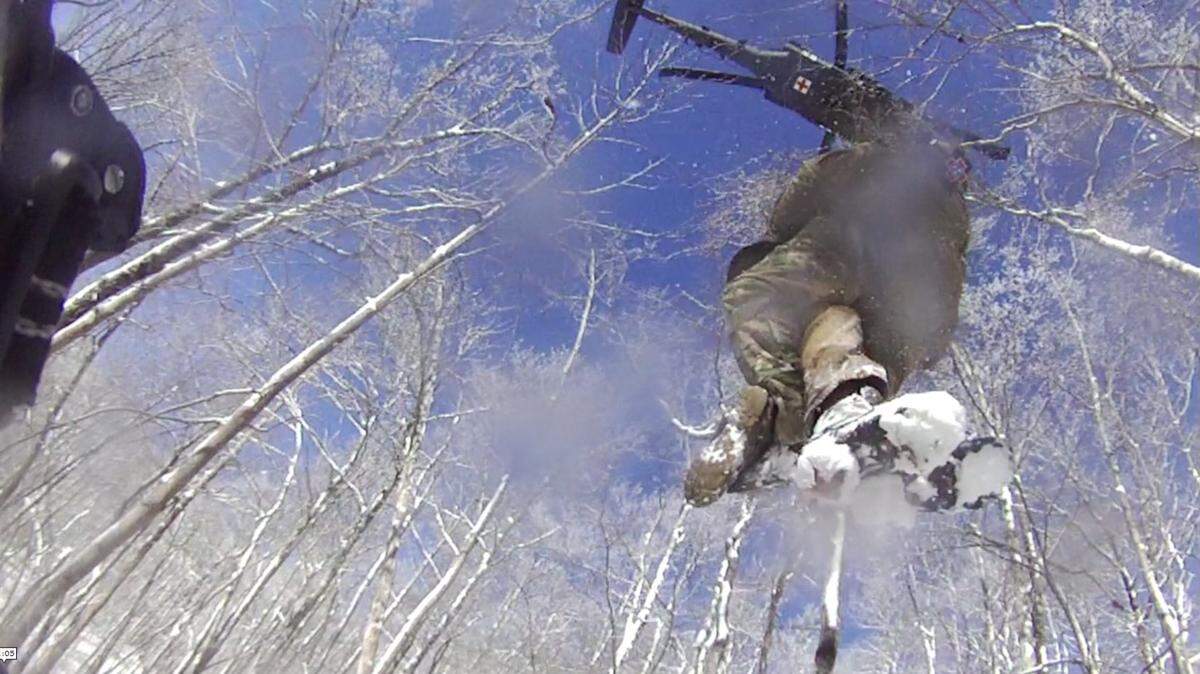 Photos released by the National Park Service show Andrew Burtzloff being lifted from the scene by cable to a helicopter.