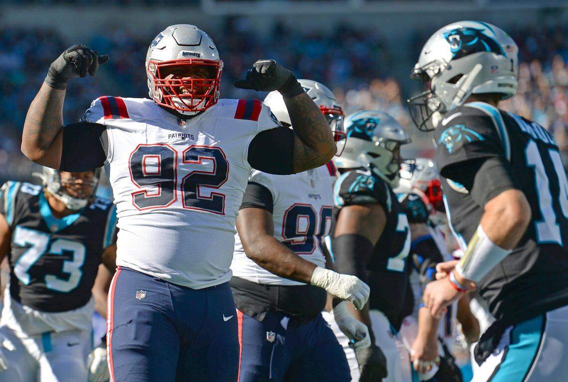 New England Patriots defensive lineman Davon Godchaux, left, flexes his muscles at Carolina Panthers quarterback Sam Darnold after the Panthers offense was stopped during the second quarter Sunday at Bank of America Stadium. The Patriots won, 24-6, and Darnold threw three interceptions.