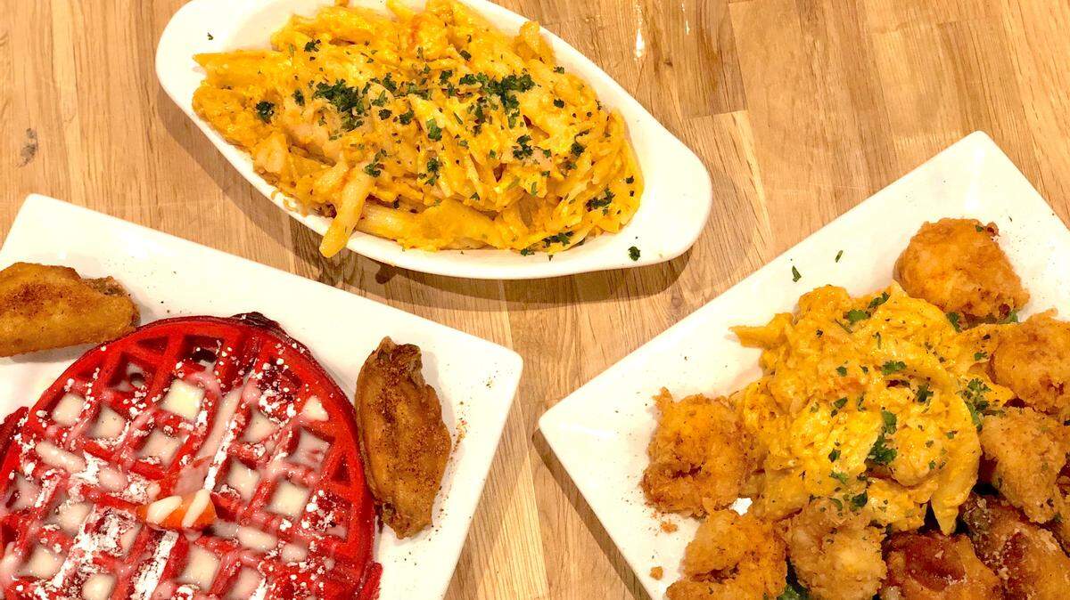 An Aunt Bungie Chicken & Red Waffle combo ($12), a half lobster mac ($7) and a combo with fried shrimp, Parmesan wings and lobster mac ($18.50) at Cuzzo’s Cuisine.