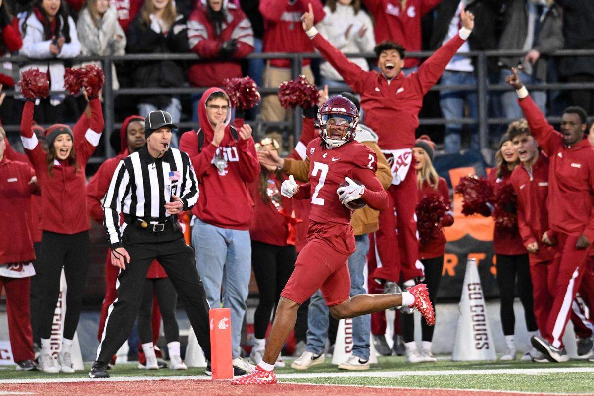 Nov 30, 2024; Pullman, Washington, USA;  Washington State Cougars wide receiver Kyle Williams (2) scores a touchdown against the Wyoming Cowboysin the first half at Gesa Field at Martin Stadium. Mandatory Credit: James Snook-Imagn Images
