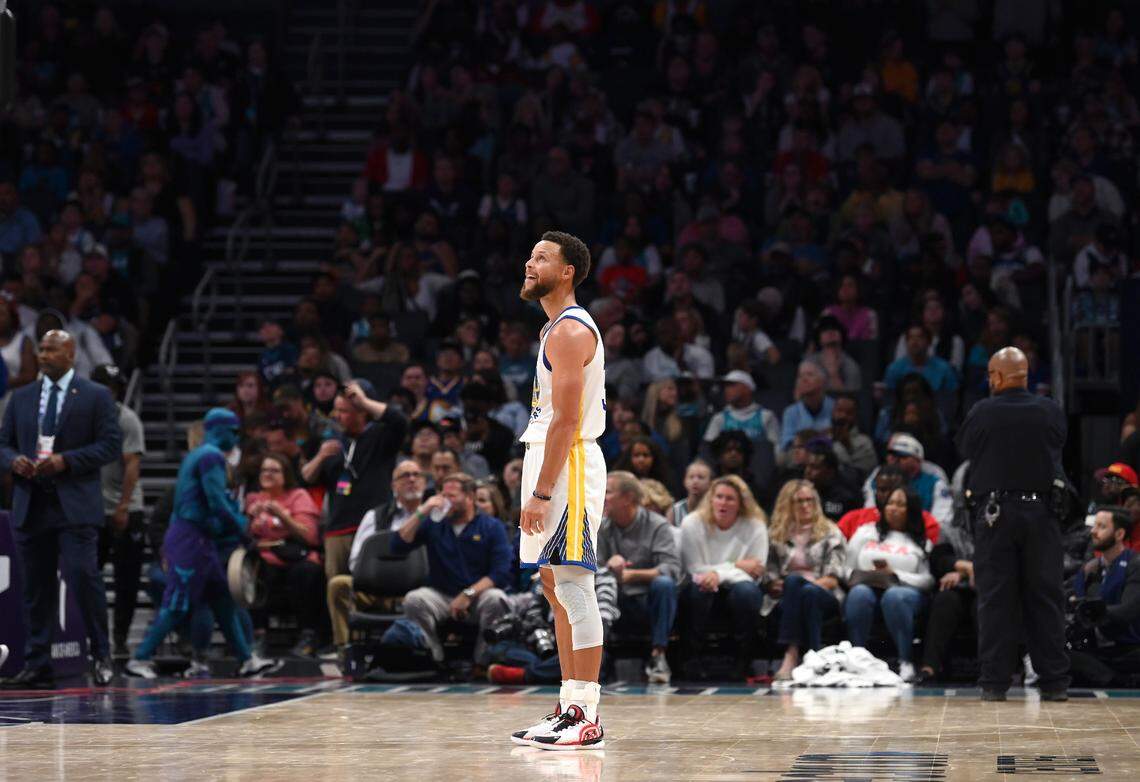 Golden State Warriors guard Stephen Curry stands on the court looking to the Jumbotron following a call against the team during second half action against the Charlotte Hornets at Spectrum Center on Saturday, October 29, 2022.
