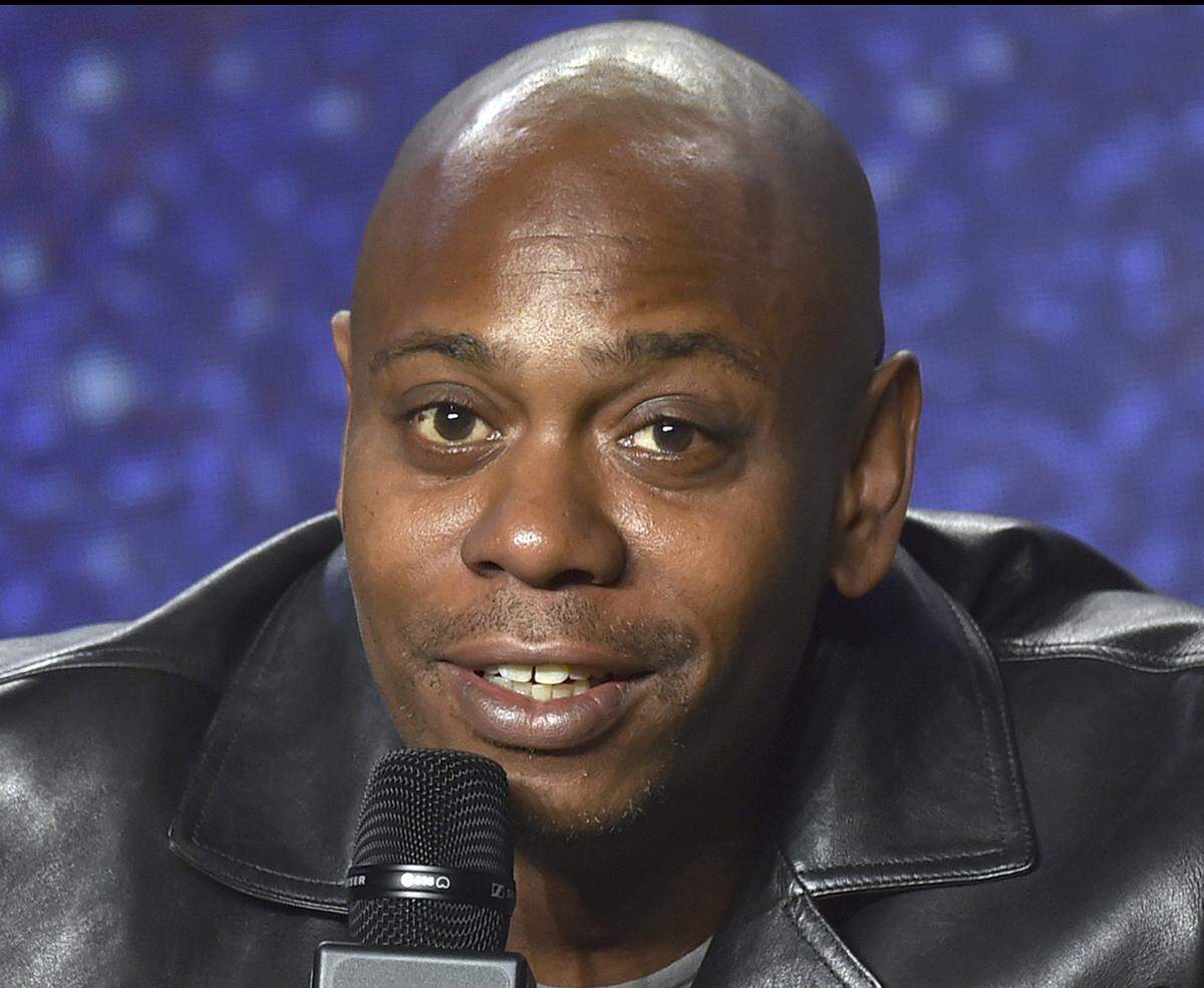 FILE - In this Sept. 9, 2018 file photo, Dave Chappelle speaks at the press conference at the Toronto International Film Festival at the TIFF Bell Lightbox in Toronto. Chappelle is among eight recipients who will honored by Harvard University with the W. E. B. Du Bois Medal during a ceremony on Oct. 11, for contributions to black history and culture.