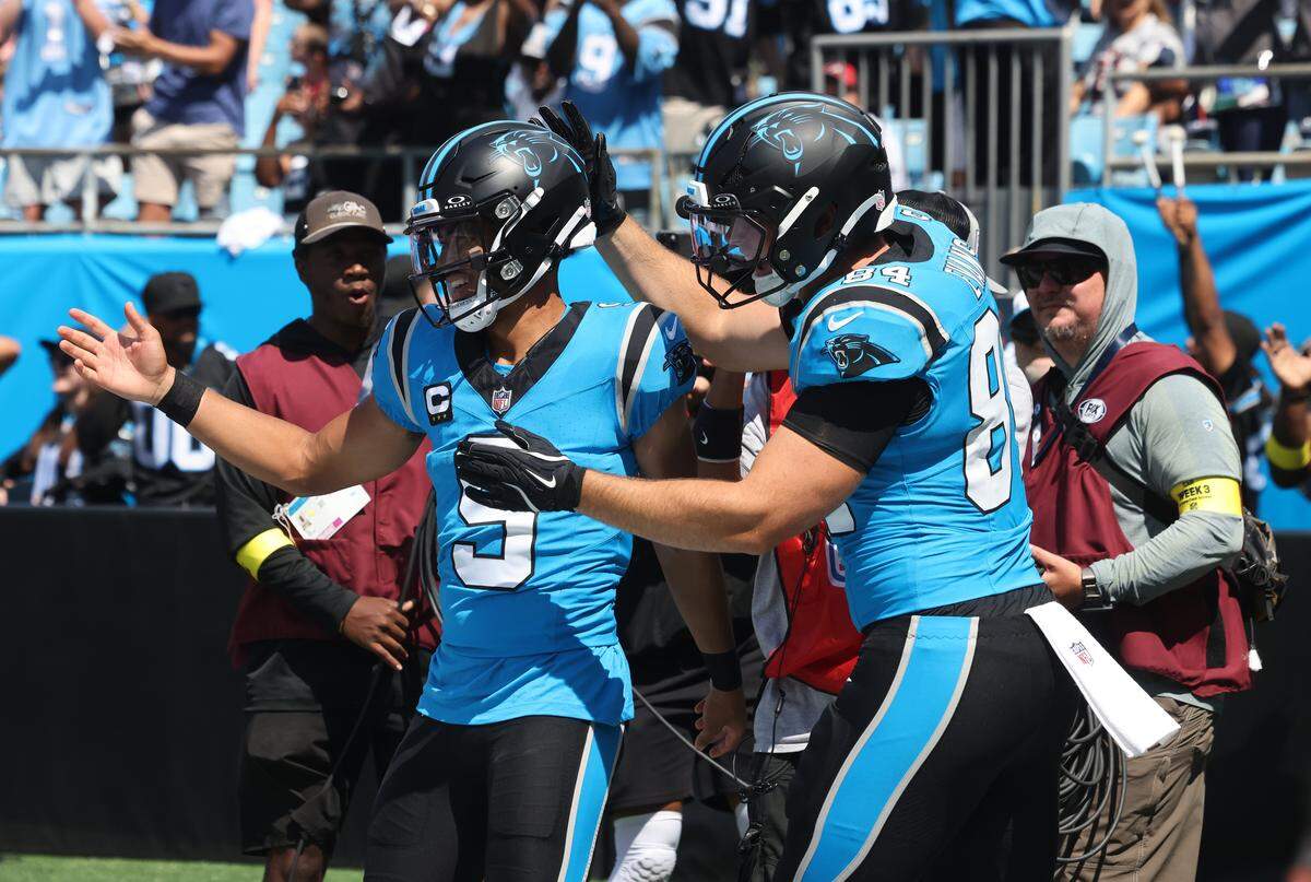 Carolina’s Mitchell Evans congratulates Bryce Young after Young scores at Bank of America Stadium in Charlotte, North Carolina, on Sept. 21, 2025.