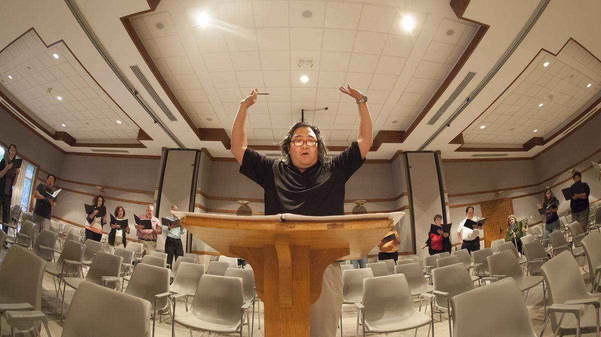 Director David Tang leads his singers during a 2015 Vox choir rehearsal at St. John’s Baptist Church in Charlotte. For this year’s concert Tang pairs two powerful and unique renderings of the Christ Passion. Performance are April 6, 7 and 14.