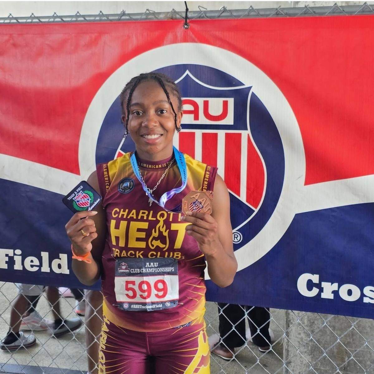 Sakeenah Odom-Pollard poses with her hardware after placing sixth (good for All-American status) in the 200-meter event at the AAU Junior Olympics this summer.