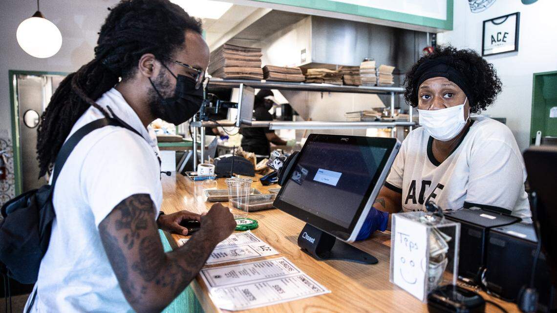 Terrence Richard, left, orders from Ebony Miller, at Ace No. 3 in Charlotte on May 20, 2021.