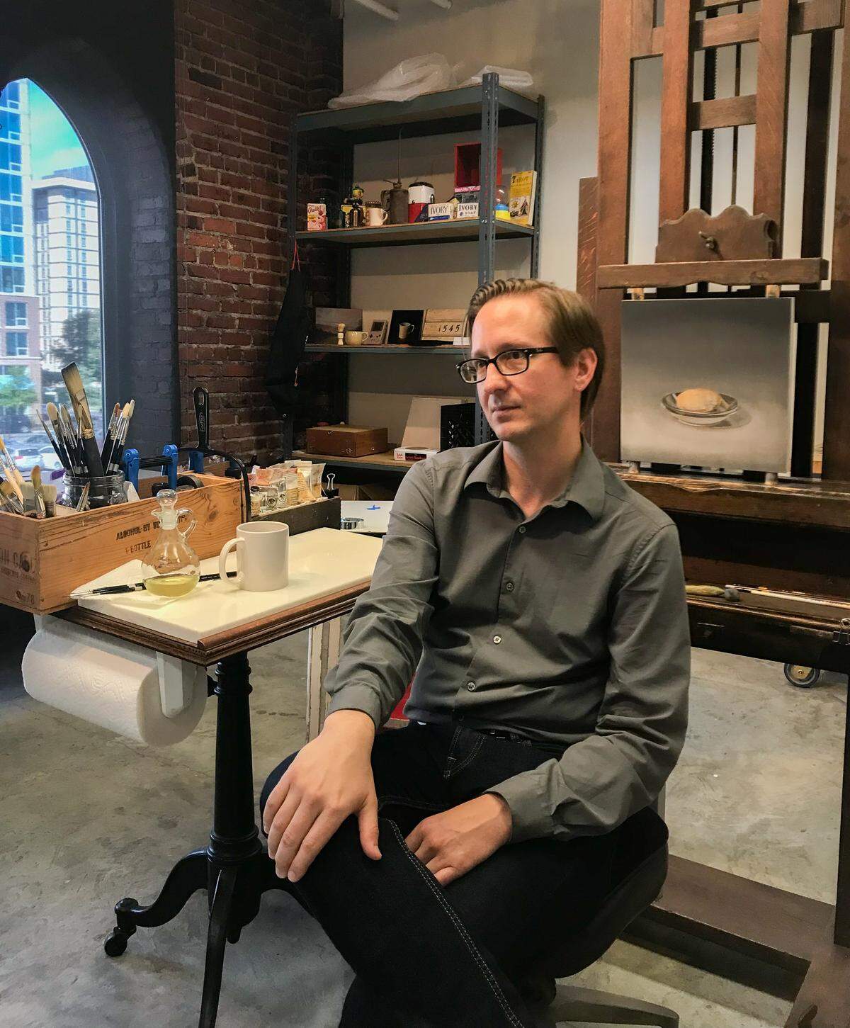 Charlotte artist Chris Clamp likes to paint everyday objects. Pictured here in his studio at the McColl Center, Clamp often paints vintage toys or tools. He wants his work to encourage viewers to reminisce. Clamp is one of six artists-in-residence at the McColl this summer.