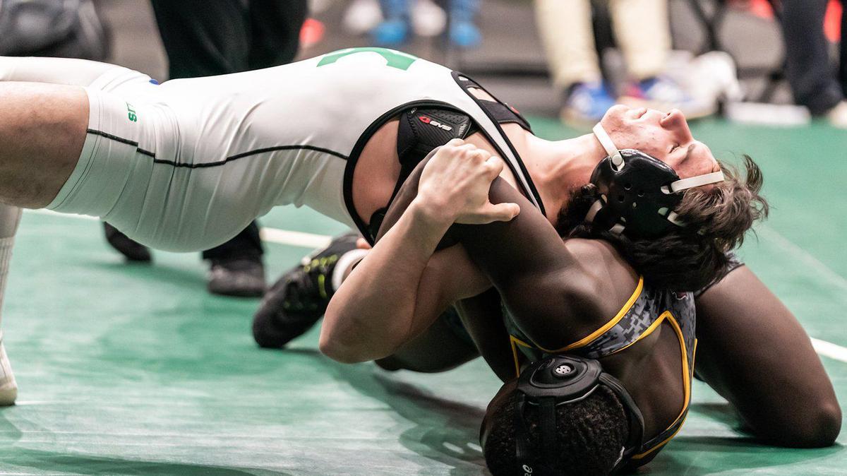 AL Brown’s Bryce Boyd, top, won the 170-pound fifth-place match at the Holy Angels Tournament at Bojangles Coliseum.