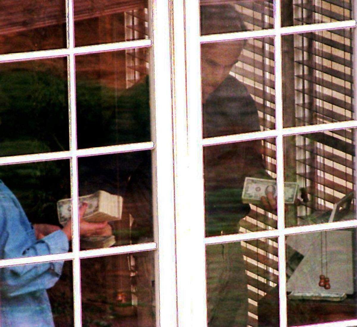 FBI agents count money found at the home of Steven and Michelle Chambers on Stuart Ridge in Cramerton on March 3, 1998. The money is believed to have been part of the Loomis Fargo heist in Charlotte in October 1997.